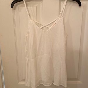 White tank top with crisscross pattern straps on the back.